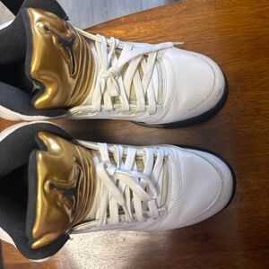 Gold and white Air Jordan’s